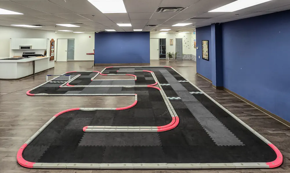 Empty foam-tile RC track laid out at HUR's new facility